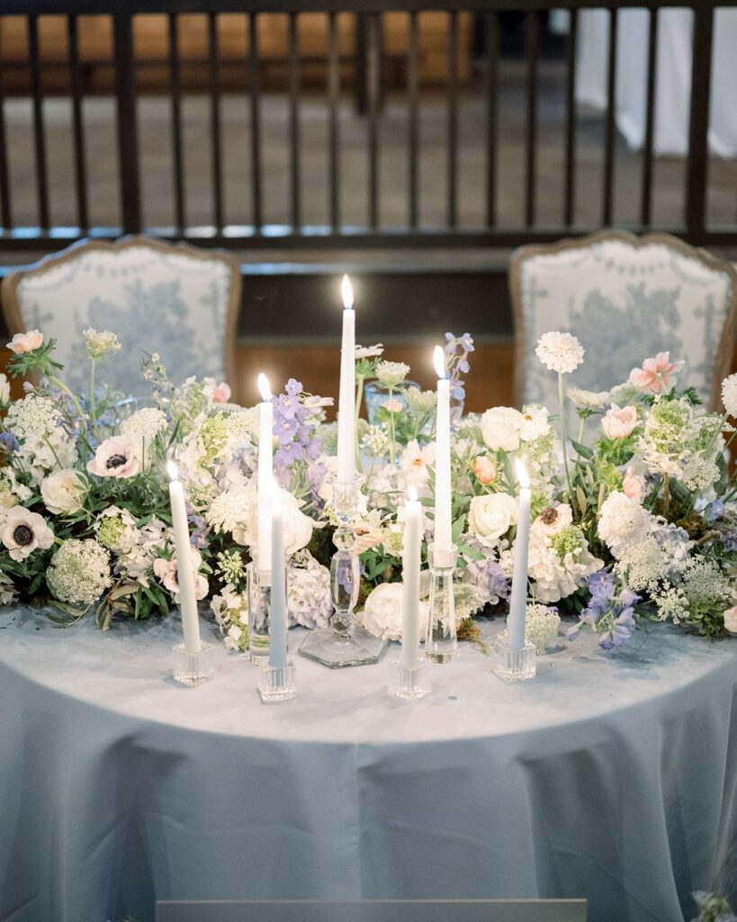 floral and candlelight sweetheart table at Iron City Bham wedding