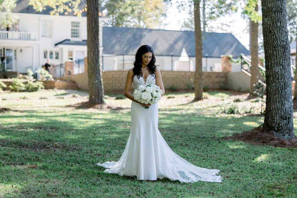 bridal portrait of bride holding her bouquet in front of SC wedding venue on wedding day