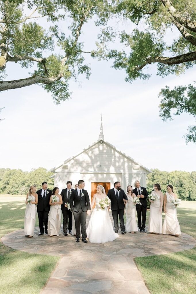 Bridal party posed outside of old country church