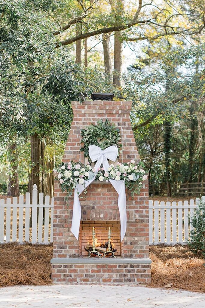 Brick fireplace decorated with bow and florals