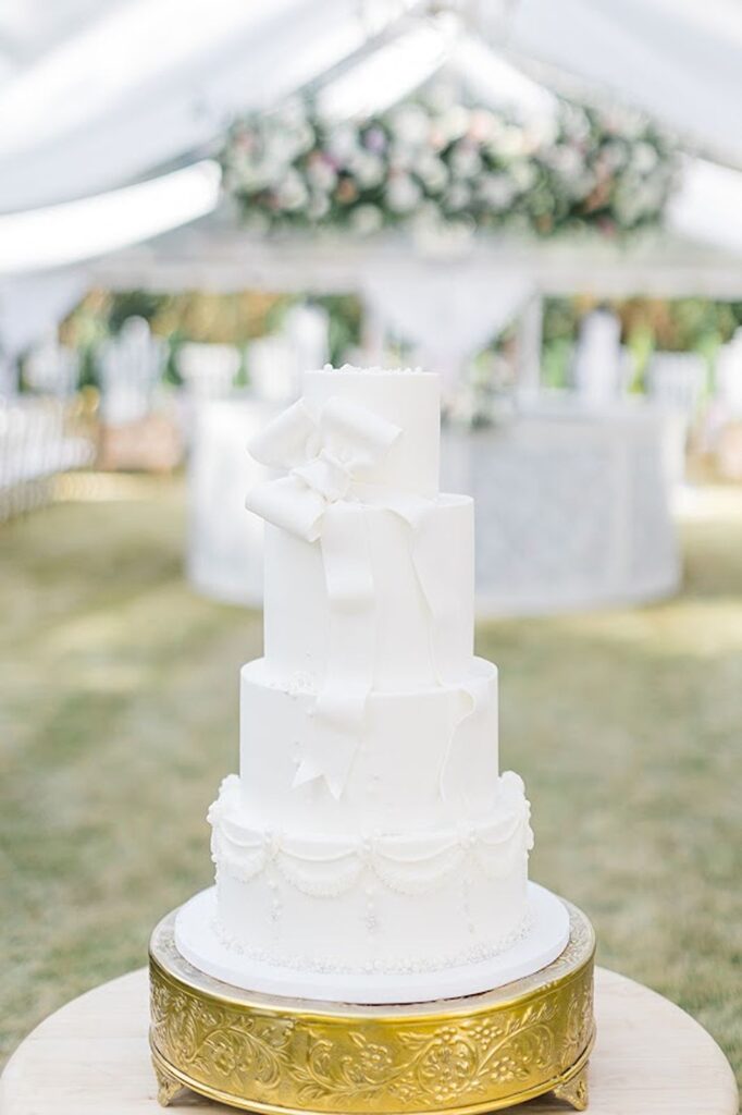 Bridgerton themed wedding cake with large bow